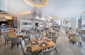a dining room with tables and chairs in a restaurant at Conrad Abu Dhabi Etihad Towers in Abu Dhabi