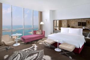 a hotel room with a bed and a large window at Conrad Abu Dhabi Etihad Towers in Abu Dhabi