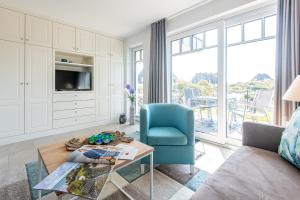 a living room with a couch and a table at Haus Dünenweg Whg 2 in Hörnum
