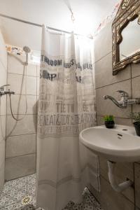 a bathroom with a shower curtain and a sink at Perfect Apartment Jaffa Beach in Tel Aviv