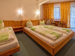 a bedroom with two beds and a table at Oberleitner XL in Brixen im Thale