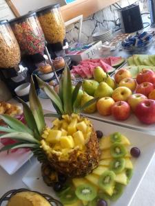 a table with a pineapple and other fruits on it at Fonte Arcada in Villa Gesell