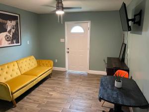 a living room with a couch and a table at Cottage close to French Quarters in New Orleans