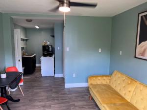 a living room with a couch and a table at Cottage close to French Quarters in New Orleans +6 photos