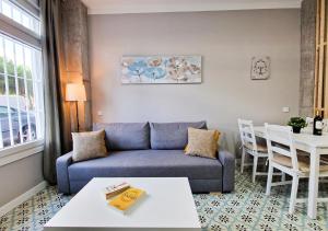 a living room with a couch and a table at Apartamentos Manzanares 'Madrid Rio' in Madrid