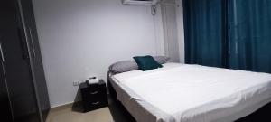 a bedroom with a bed with a pillow on it at Apto los Almendros in Cartagena de Indias