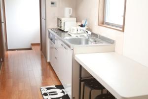 a kitchen with a sink and a microwave at Chiba - House - Vacation STAY 87410 in Chiba