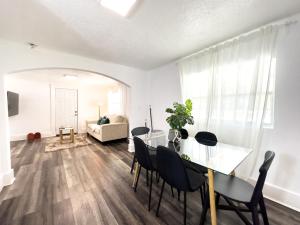 a dining room with a table and chairs and a couch at 2b1b Stylish Little House W Shared Pool 511 in Clearwater