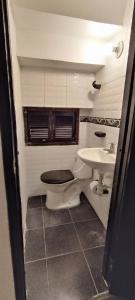 a bathroom with a toilet and a sink at Apto los Almendros in Cartagena de Indias