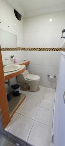 a bathroom with a white toilet and a sink at Apto los Almendros in Cartagena de Indias