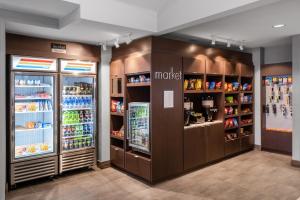 a grocery store aisle with two refrigerators at Residence Inn Denver Southwest/Lakewood in Lakewood