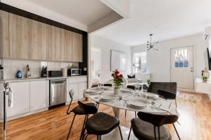 a kitchen and dining room with a table and chairs at Unbeatable 3BR with Private Patio in Upper East Side in New York