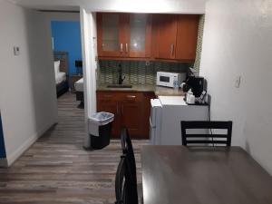 a kitchen with brown cabinets and a white refrigerator at Sandalwood Beach Resort in St. Pete Beach