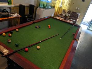 a pool table with balls on it in a living room at Hotel Bella Vida in Lomé