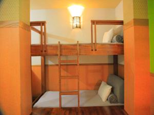 a bunk bed with a ladder in a room at HOTEL 紅-bin- in Okinawa City