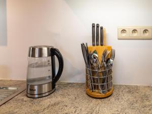 a blender sitting on a counter with a container of utensils at Stunning home for 5 adults with indoor pool in Esneux