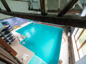 an overhead view of a swimming pool in a building at Stunning home for 5 adults with indoor pool in Esneux