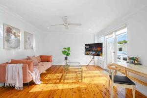 a living room with a couch and a flat screen tv at Victorian Dream Terrace CBD in Sydney