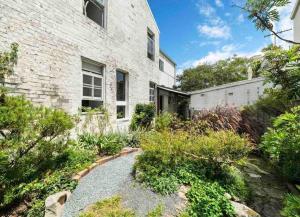 a brick house with a garden in front of it at Victorian Dream Terrace CBD in Sydney