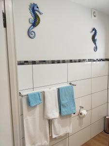 a bathroom with blue and white towels on a rack at GOLDFIELDS STUDIO APARTMENT, Beaconsfield - Fully Self-contained, air-conditioning in Beaconsfield
