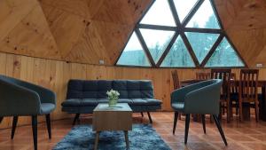 a living room with blue couches and a table at Domos Maran in Villarrica +11 photos