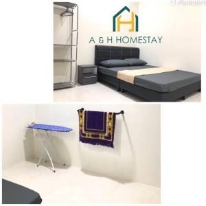 a homeway bedroom with a bed and a table at A&H Homestay Teluk Intan in Teluk Intan