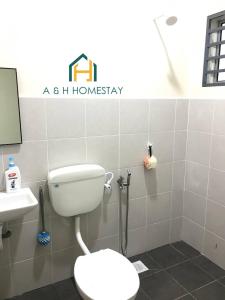 uma casa de banho com um WC e um lavatório em A&H Homestay Teluk Intan em Teluk Intan