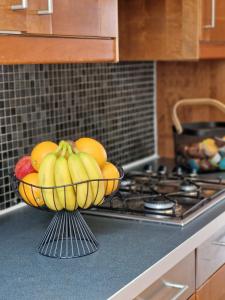 a bowl of bananas and oranges on a counter in a kitchen at Farringdon in London