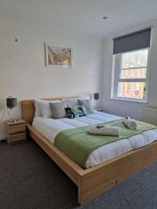 a bedroom with a large wooden bed with a window at Farringdon in London