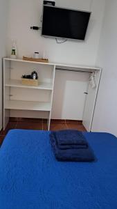 a bedroom with a bed and a tv on a wall at Residencial SOL NACIENTE in Pozo Almonte