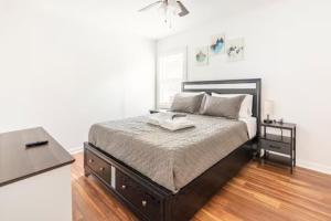 a bedroom with a large bed with a black frame at A Place to Escape 5 minutes from Downtown Newly Renovated in Birmingham