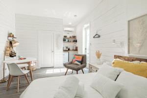 a bedroom with a bed and a desk and a chair at Vanderbilt Beach Studio in Naples