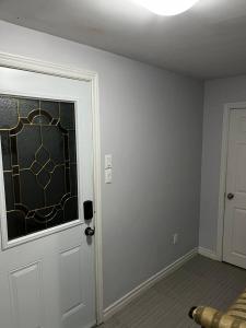 a room with a door with a stained glass window at 1 bedroom with private entrance in Ajax