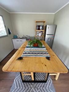 a wooden table in a room with a kitchen at Casa Montegrande in Monte Grande