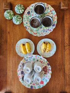 a wooden table with plates of desserts on them at D'flora Glamping in Noca