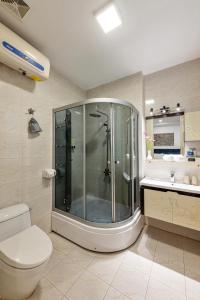 a bathroom with a shower and a toilet and a sink at Golden Sun Hotel in Hanoi