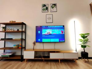 a living room with a flat screen tv on a table at Monstera Meritus Homestay - Penang Butterworth Prai 1-8PAX in Perai