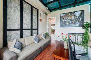 a living room with a couch and a table at Golden Sun Hotel in Hanoi