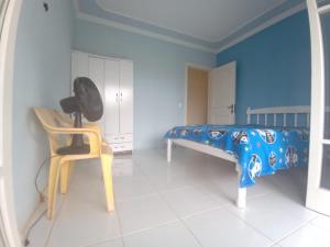 a room with a bed and a chair in it at Casa Veraneio pra família toda! in Xangri-lá +27 photos