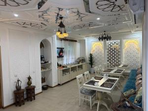 a living room with a dining table and chairs at Boutique Safiya in Bukhara