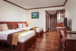 Postel nebo postele na pokoji v ubytování Angkor Paradise Hotel