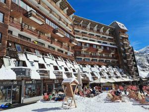 a large building with people sitting in chairs in the snow at Studio Avoriaz, 1 pièce, 4 personnes - FR-1-314-170 in Morzine