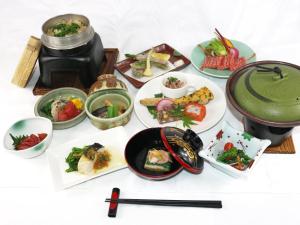 a group of plates of food on a table at Tabist Niitsuru Onsen Nda in Aizumisato