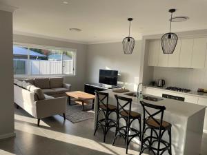 a kitchen and living room with a couch and a table at 21 On Court in Mudgee