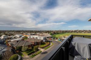 a view of a city from a balcony at Moonee Valley Park with parking in Melbourne