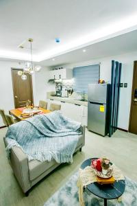 een keuken en een woonkamer met een bank en een tafel bij Comfortable Stay at One Oasis in Cebu City