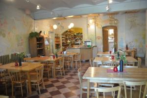 a restaurant with wooden tables and chairs in a room at Krimuldas Muiža in Sigulda