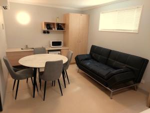 a living room with a couch and a table at Lake Tyrrell Accommodation LTA in Sea Lake