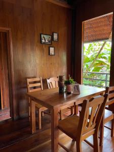 a wooden table and chairs in a room at Chez DARA in Mon Jam