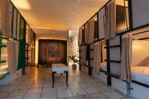 a room with bunk beds and a table in it at Bposhtels San Juan in San Juan